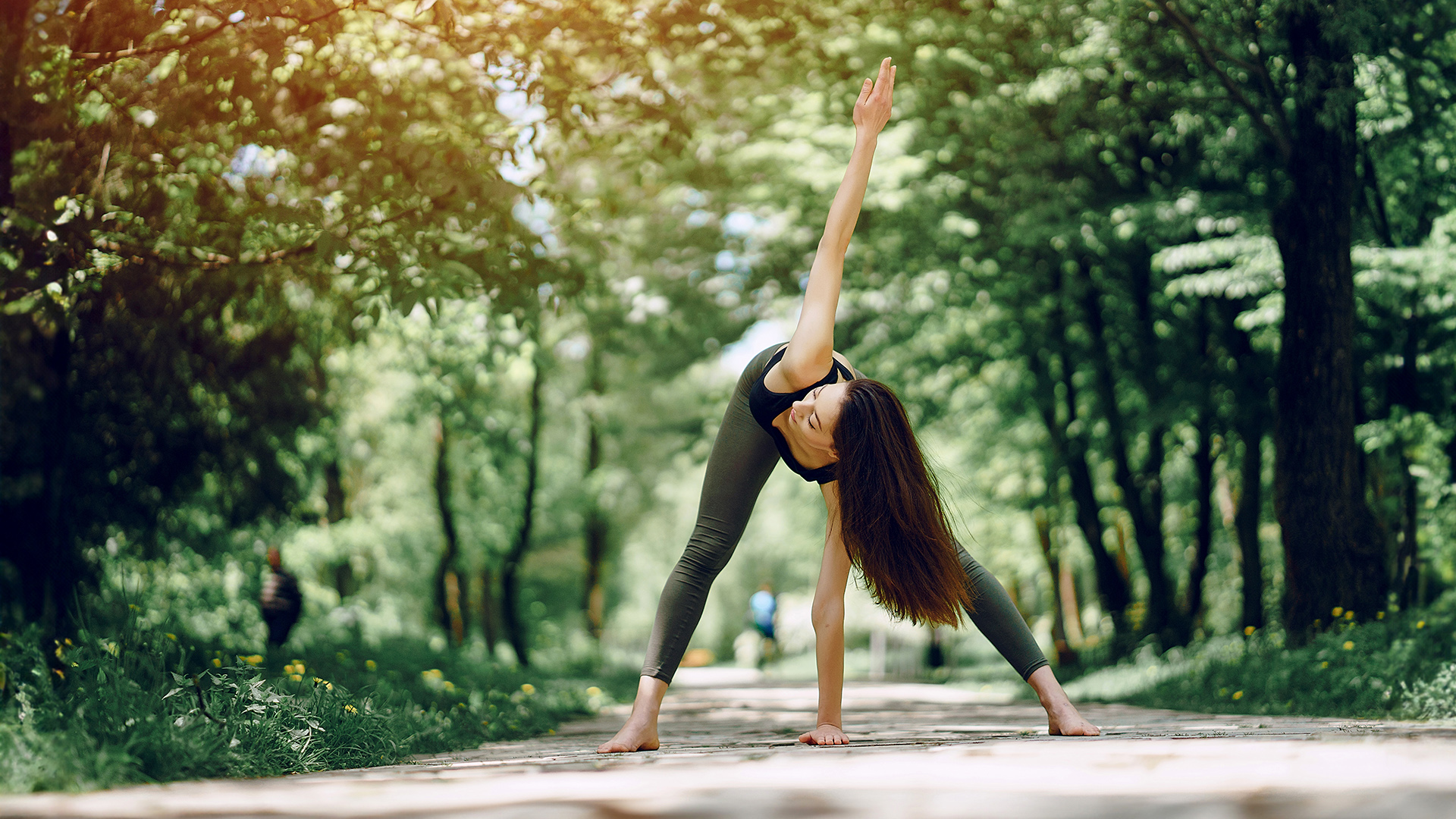 Beautiful and slender girl doing yoga in nature